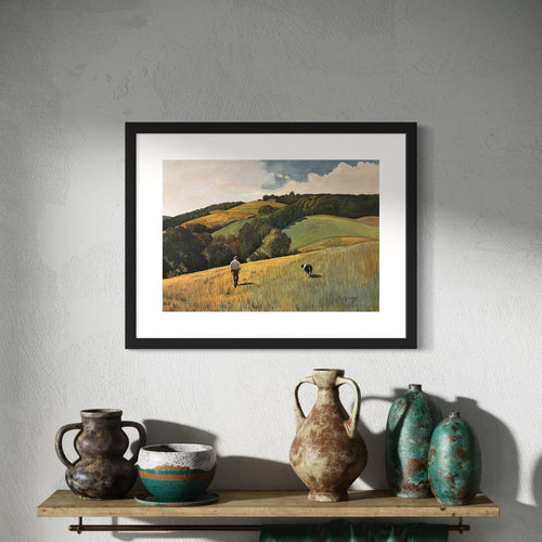 Framed landscape painting on a wall with rustic vases below